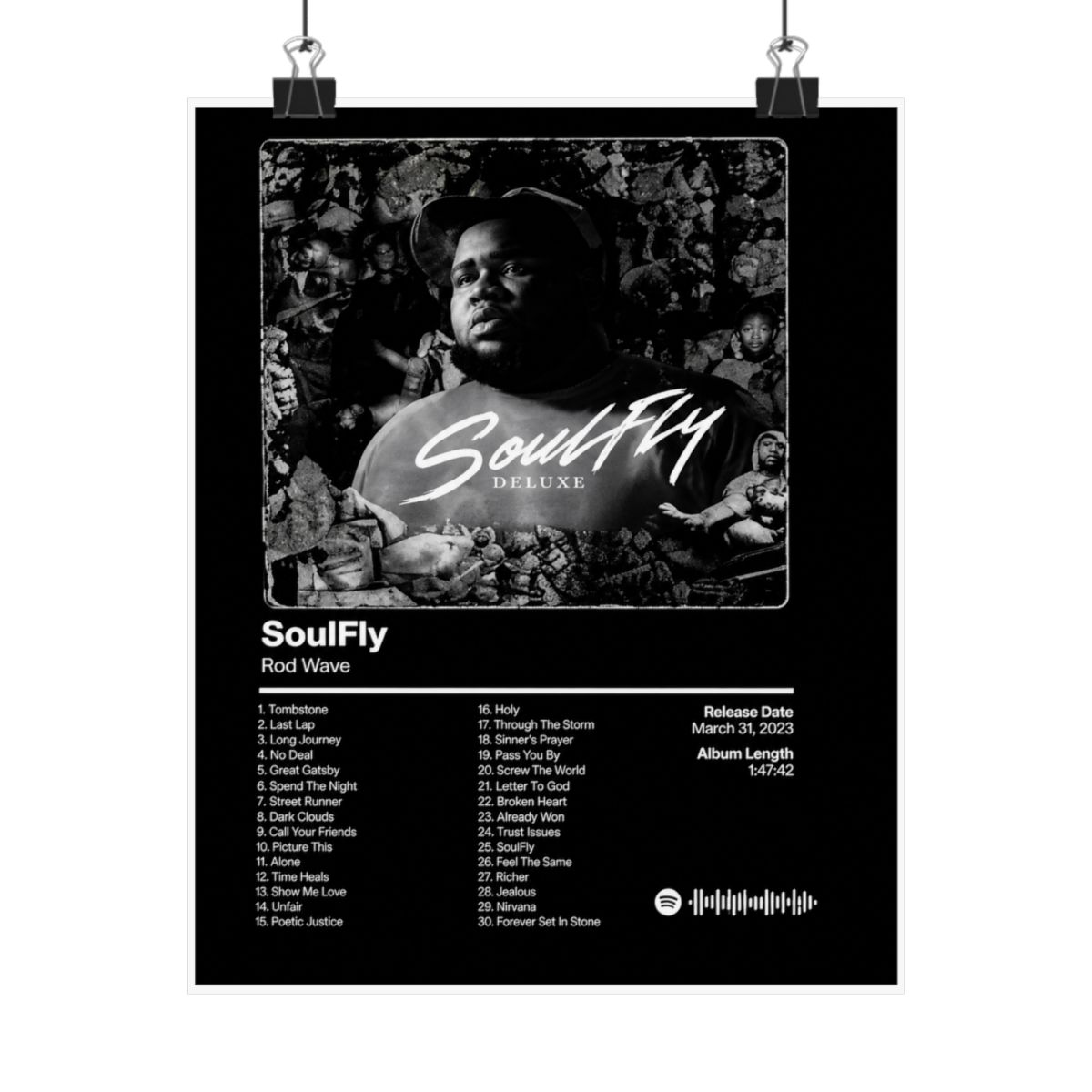 A framed black and white poster of the "SoulFly Deluxe" album by Rod Wave. The poster displays the album title, artist, tracklist, release date, and album length. The image is set against a dark...